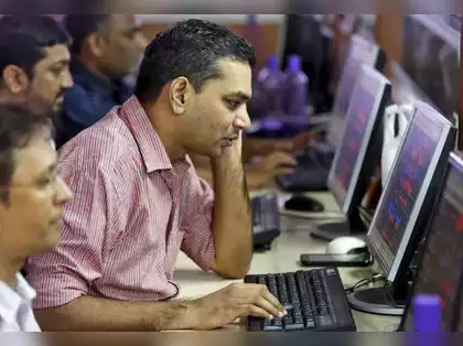 brokers trade at computer terminals at stock brokerage firm in mumbai.jpg